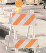 [Image Description: An orange and white stripped barrier.]