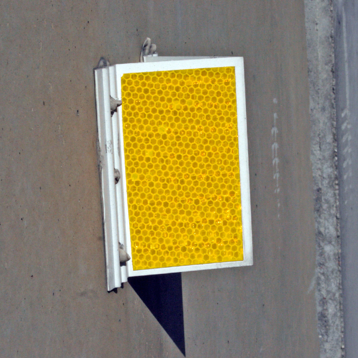 [Image Description: An A-Frame Delineator mounted on a concrete barrier.]