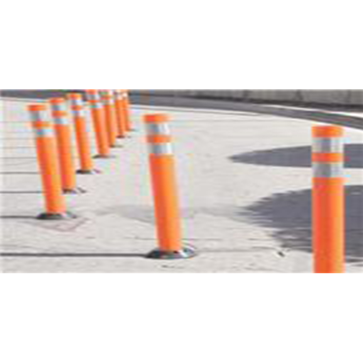 [Image Description: A row of orange cylindrical pole style delineators lined up on a road.]